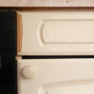 image of the kitchen cupboards with peeling off plastic, part of Covid chronicles